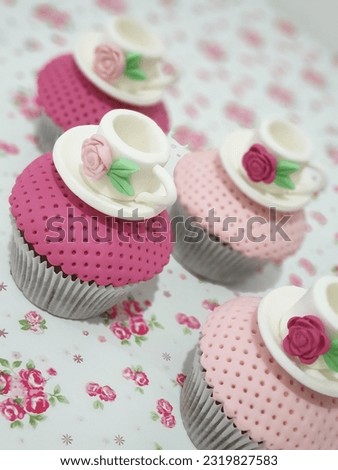 In the picture, a delightful cupcake takes center stage, enticing both the eyes and the taste buds. The cupcake sits proudly on a dainty, decorated paper liner, its perfectly baked golden-brown exter