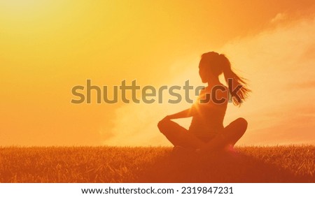 Young Adult Woman Doing Stretching Exercise Enjoying Summer Morning in Beautiful Landscape with Orange Sky.