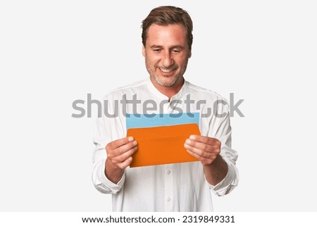 Middle-aged gentleman captivated by letter in this pensive studio portrait, exuding sincerity and depth.
