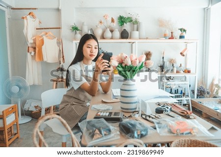 Small business owners are taking pictures of products to send to customers who will shop and take orders that customers order from an online retailer - online shopping.