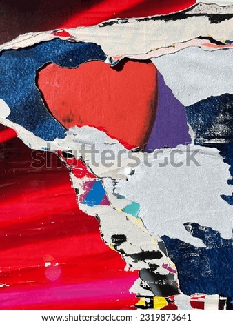 Colourful abstract paper pattern of torn yanked tugged street poster placard layers   