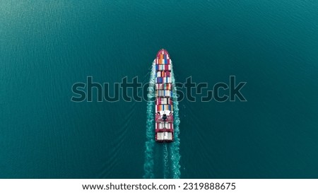 Aerial Stern of cargo container ship with contrail in the ocean ship carrying container and running for export concept technology freight shipping by ship at sunset