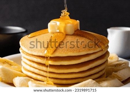 Pour plenty of over the pancakes Royalty-Free Stock Photo #2319891715