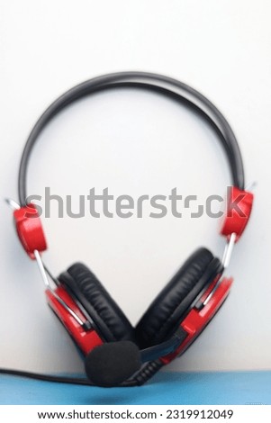 Heanset earphones, audio listening devices in black and red on a white background