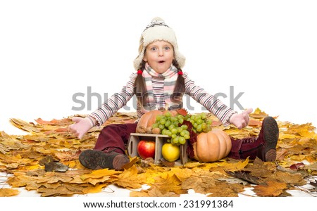 girl with fruits and vegetables on autumn leaves on white