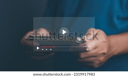 Man playing video game on his mobile phone. Online movie streaming with smartphone. Person watching video on internet with an imaginary video player service.
