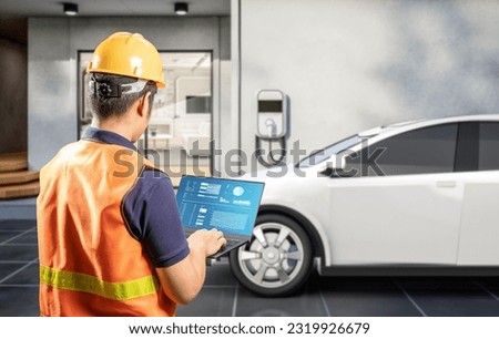 Asian engineer or technician install home ev charger Royalty-Free Stock Photo #2319926679