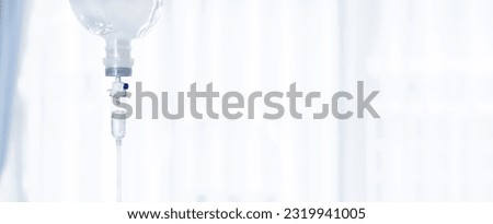 Close up saline bag IV drip for patient and Infusion pump in hospital patient room Royalty-Free Stock Photo #2319941005