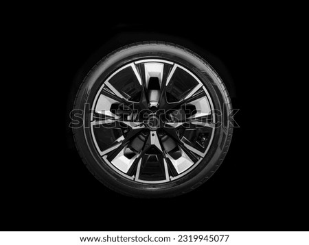 Car alloy wheel and tyre isolated on black background. New alloy wheel with tire. Alloy rim isolated. Car wheel disc. Car spare parts. Royalty-Free Stock Photo #2319945077