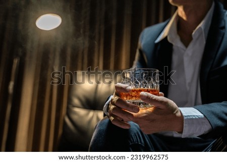 Businessmen in suits drinking  Celebrate whiskey. Royalty-Free Stock Photo #2319962575