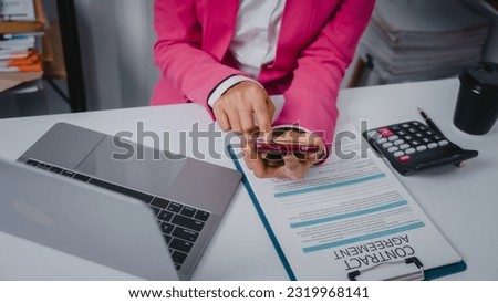Excited Asian bookkeepers doing bookkeeping, accounts payable, assets, book value, equity, inventory, liabilities, cost of goods sold, depreciation, expenses, Gross profit, diversification, liquidity Royalty-Free Stock Photo #2319968141