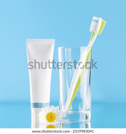 A clean and refreshing image featuring toothpaste and toothbrushes, promoting oral hygiene and a bright smile Royalty-Free Stock Photo #2319983041