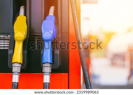 fuel gas station, closeup gasoline fuel nozzle petroleum benzine and diesel or gasohol colors type. Royalty-Free Stock Photo #2319989063