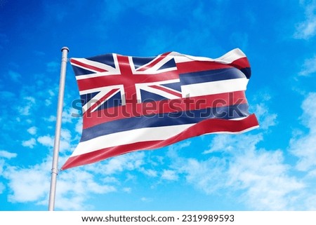 Hawaii flag waving in the wind, blue sky background