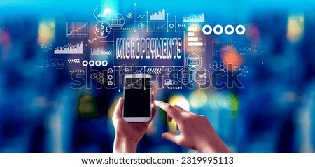 Micropayments theme with person using a smartphone in a city at night Royalty-Free Stock Photo #2319995113
