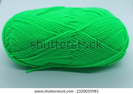 A green yarn on a white surface