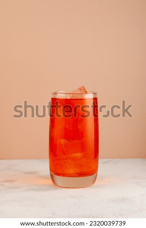 Refreshing cold drink.  Summer fruit lemonade with ice in a tall glass. Royalty-Free Stock Photo #2320039739