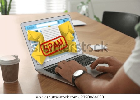 Spam warning message, envelope illustrations popping out of device display. Man using email software on laptop at table, closeup