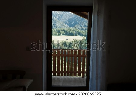 View from bedroom window of natural landscape of green hill range