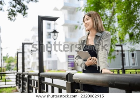 asian manager businesswoman use tablet for working online outdoor 