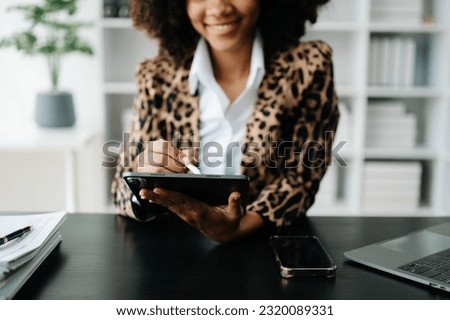African Woman using smart phone for mobile payments online shopping,omni channel,sitting on table,virtual icons graphics interface screen in morning light
