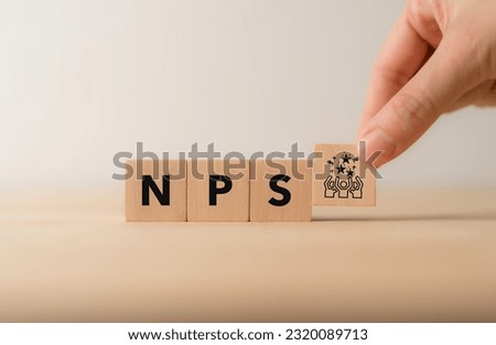 Net Promoter Score (NPS) measuring customer satisfaction and loyalty concept.Tool for measure customer loyalty and improvement products or services. Wooden cube blocks with NPS text and icon. Royalty-Free Stock Photo #2320089713