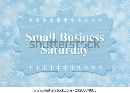 Small Business Saturday sign with snowflakes for shop local message Royalty-Free Stock Photo #2320094803