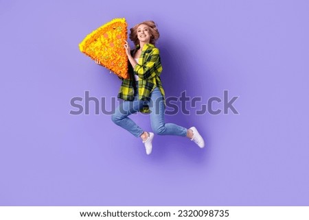 Full length photo of cheerful pretty woman dressed checkered jacket jumping high rising pizza pinata isolated purple color background Royalty-Free Stock Photo #2320098735