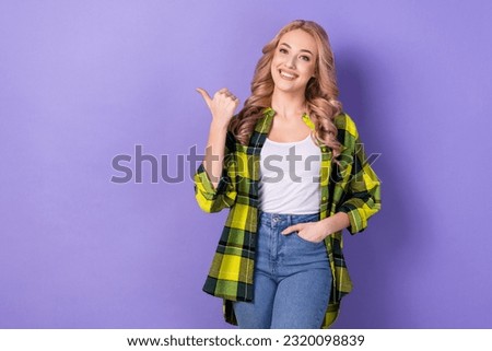 Photo young woman selling agent advertising clothes wear plaid shirt denim pants new store isolated violet color background