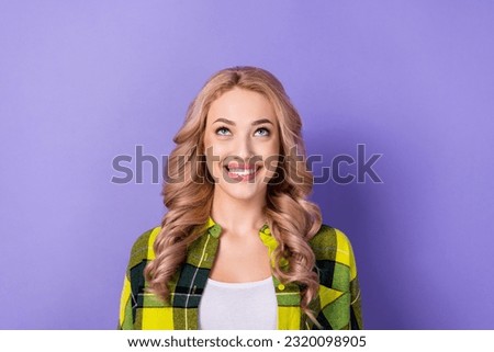 Photo of cute lady look up empty space read good news low prices store wear plaid shirt isolated pastel color purple background