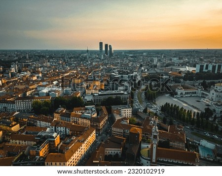 Aerial view of Milan cityscape with evening sunset. Milan, Italy. Skyscrapers in the background City Life Milan and Cimitero Monumentale Royalty-Free Stock Photo #2320102919