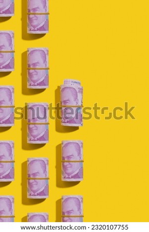 Turkish lira money rolls flat lay on yellow background