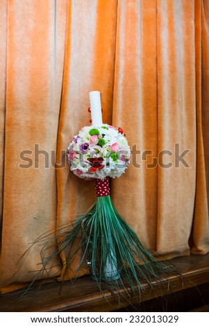 Floral arrangement on a baptismal candle