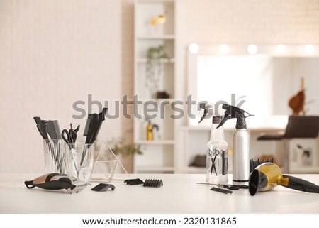Different hairdressing tools on table in beauty salon Royalty-Free Stock Photo #2320131865