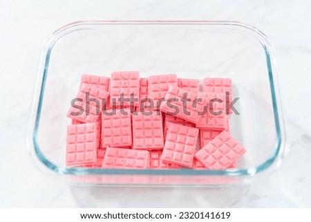 Homemade mini pink chocolates in a food glass container. Royalty-Free Stock Photo #2320141619