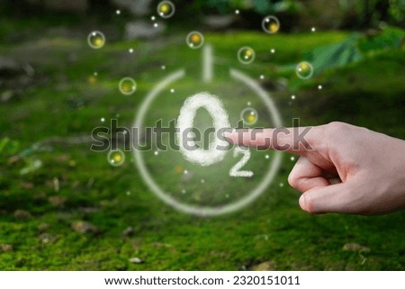 Hand pointing at O2 or oxygen sign. concept of fresh air breathing, purifying process. Nature environmental, biodiversity. Good health. Eco friendly. ESG, Plant release oxygen. Green forest. Freshness