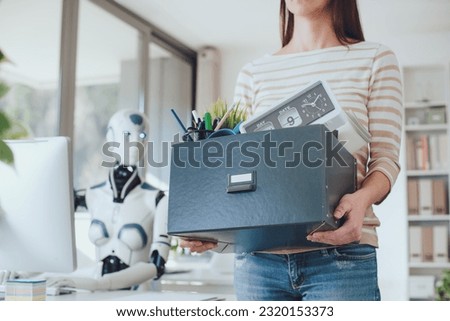 Dismissed office worker leaving her workplace and humanoid robot staring at her: the impact of AI on employment Royalty-Free Stock Photo #2320153373