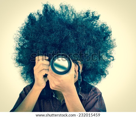 Professional Photographer take photo concept, Man with long hair and holding digital camera vintage style