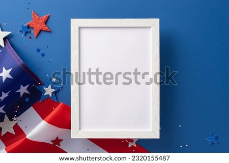 National Labour Day concept. Top view photo of empty rectangular wooden frame with american flag and white, red and blue star-shaped sparkles on blue isolated background with copy-space