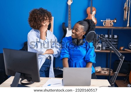 African american women musicians using laptop composing song at music studio