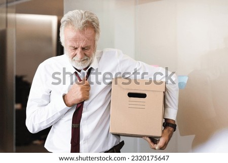 Senior employee carrying stuff box and ready to retired from company. Royalty-Free Stock Photo #2320175647