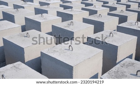 Symmetric view of many Concrete Anchors for posting Undersea Mooring Buoys in industrial yard area