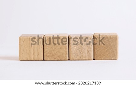 Four empty wooden cubes on white background for your text. Empty space for business concept templates and banners.