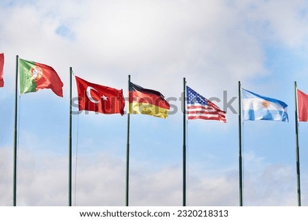 Germany, USA, Turkey, Portugal and Argentina flags on blue sky