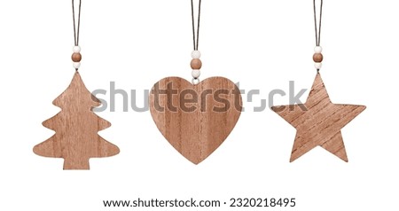 Set of hanging brown wooden ornament. Christmas tree, heart and star isolated on white background. Stock photo