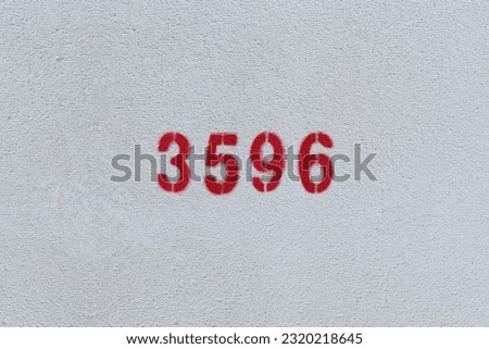 Red Number 3596 on the white wall. Spray paint.
