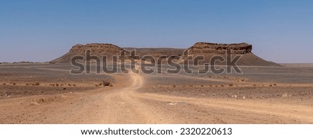 Iconic horseshoe mountain Gara Medouar in the desert near Merzouga, known for different film sets, Morocco