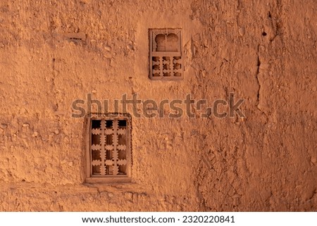 Two little windows in a typical berber house built of clay, Draa valley in Morocco