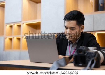 Photographer Journalist man working on laptop during work at home office. Freelance working online