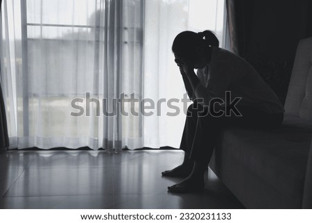 Depression person of a young woman is unhappy. Loneliness man sitting alone. Woman disappointment and hopeless. despair, headache as crying. Man is upset, frustration, tired and negative feeling. Royalty-Free Stock Photo #2320231133